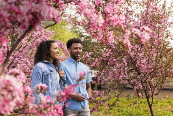 Young couple walks through a blooming garden in Kansas