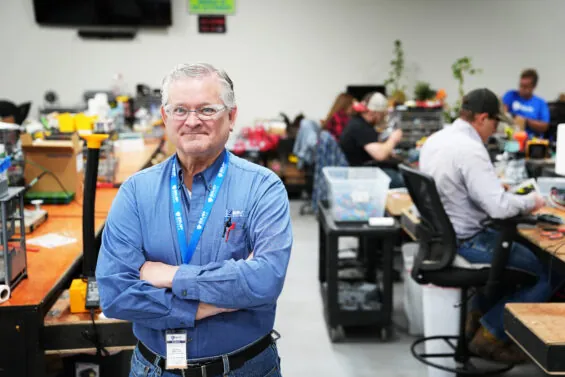 Kansas veteran employment resource manager with workers behind him