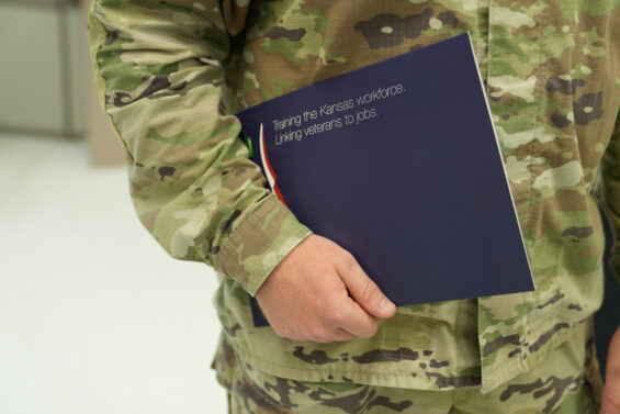 Military service member with Kansas veteran employment resources pamphlet