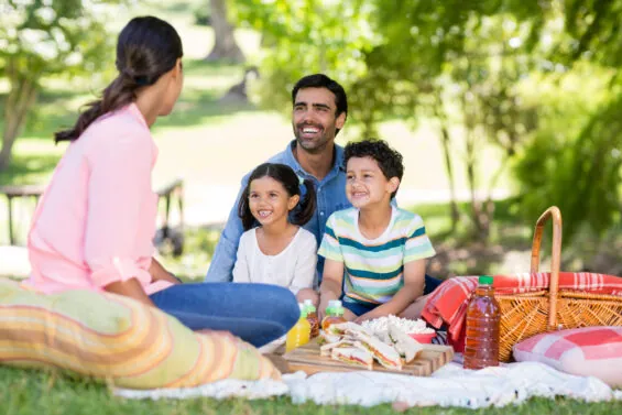 Afamily having a picnic in the park