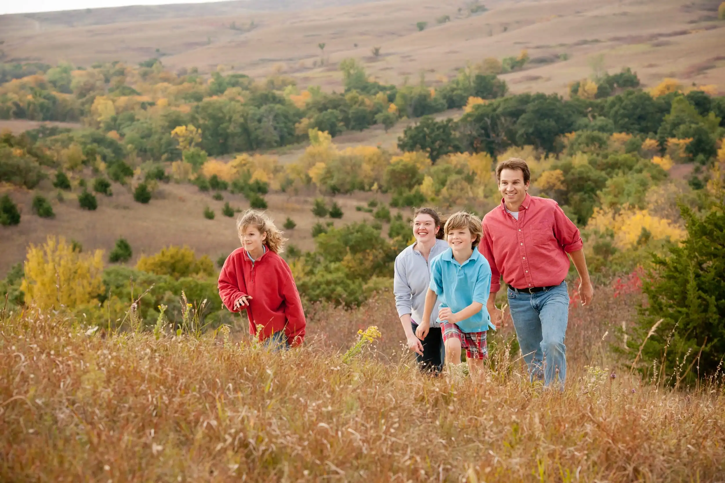 Family smiling and hiking in the flint hills.